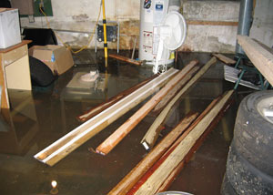 A severely flooding basement in Deer Park, with lumber and personal items floating in a foot of water