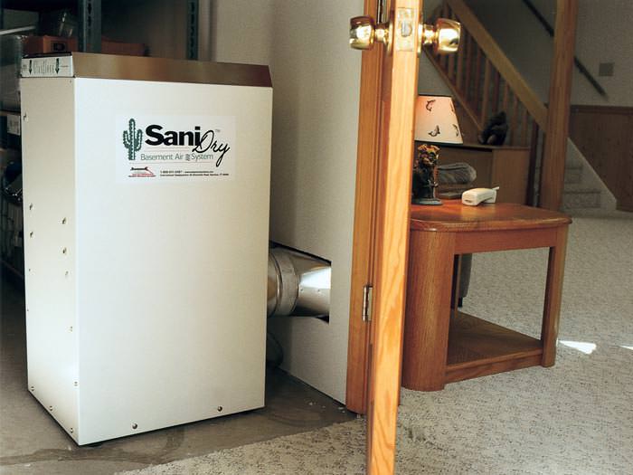 A basement dehumidifier with an ENERGY STAR® rating ducting dry air into a finished area of the basement  in Elk